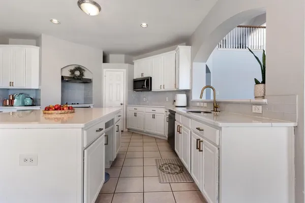 a kitchen with stainless steel appliances a stove microwave and cabinets