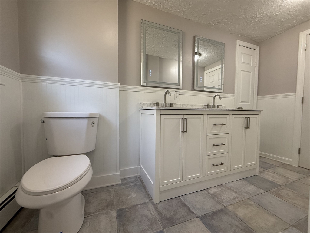 165 Hedges Pond Road Plymouth, MA 02360 - Photo 11 of 20 a bathroom with a toilet a sink and mirror