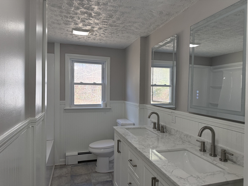 165 Hedges Pond Road Plymouth, MA 02360 - Photo 12 of 20 a bathroom with a granite countertop sink toilet and a mirror