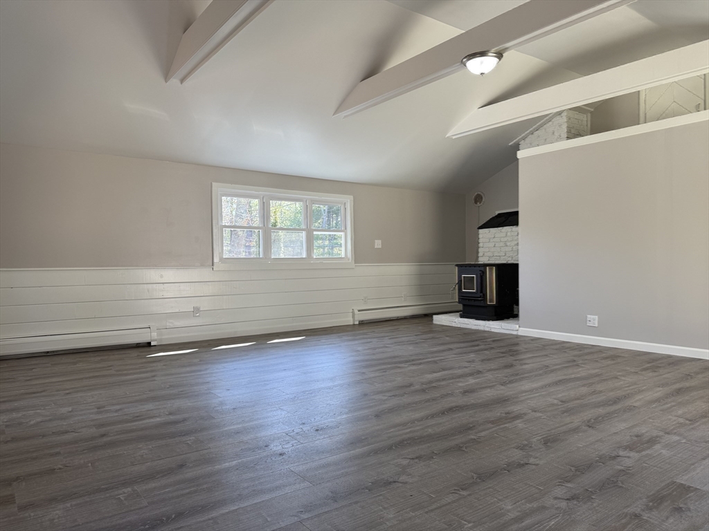 165 Hedges Pond Road Plymouth, MA 02360 - Photo 16 of 20 an empty room with wooden floor and windows
