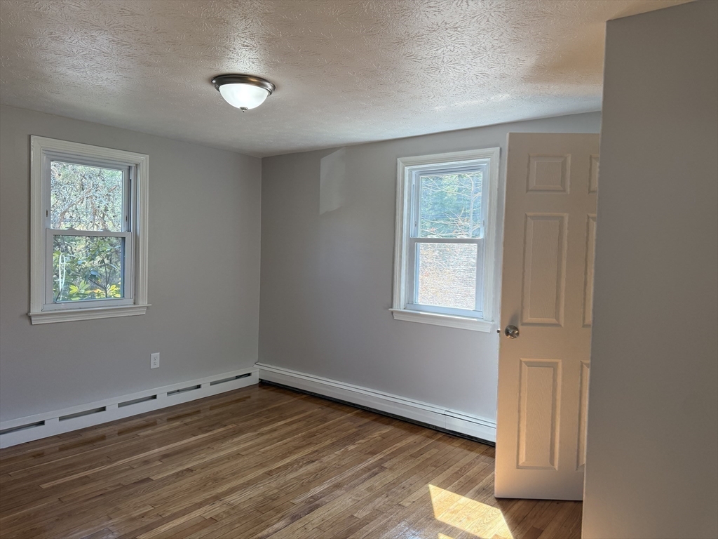 165 Hedges Pond Road Plymouth, MA 02360 - Photo 19 of 20 a view of an empty room with wooden floor and a window