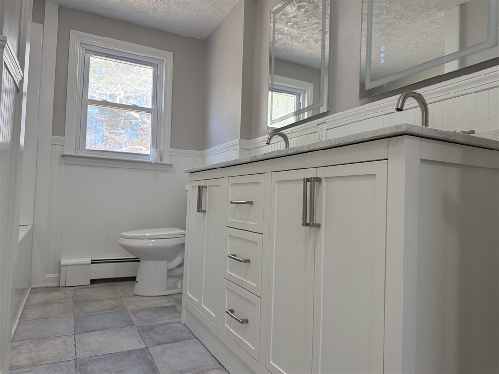 165 Hedges Pond Road Plymouth, MA 02360 - Photo 9 of 20 a bathroom with a toilet sink and cabinets