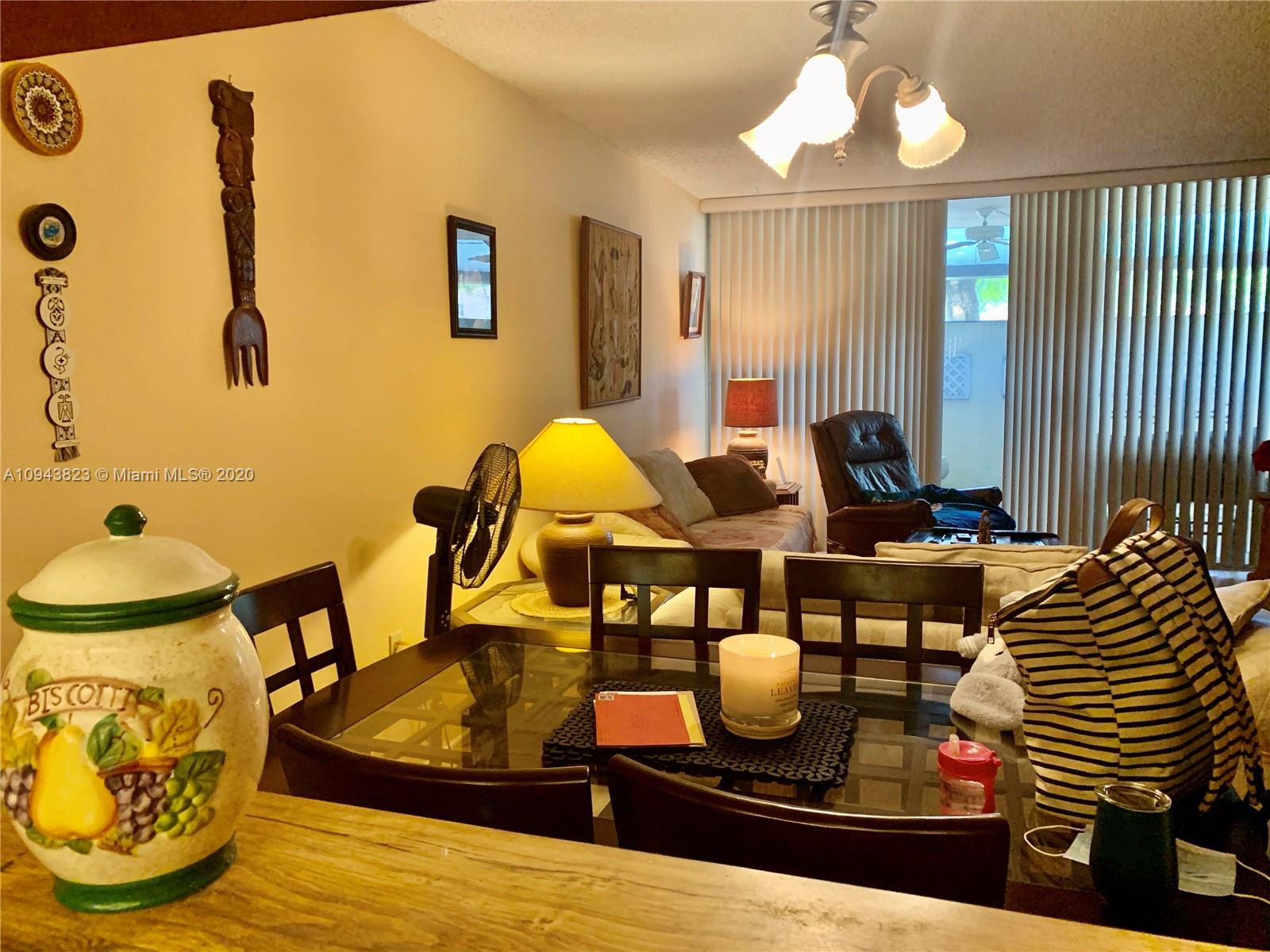 10975 Southwest 107th Street, Unit 117 Miami, FL 33176 - Photo 12 of 13 a view of a dining room with furniture