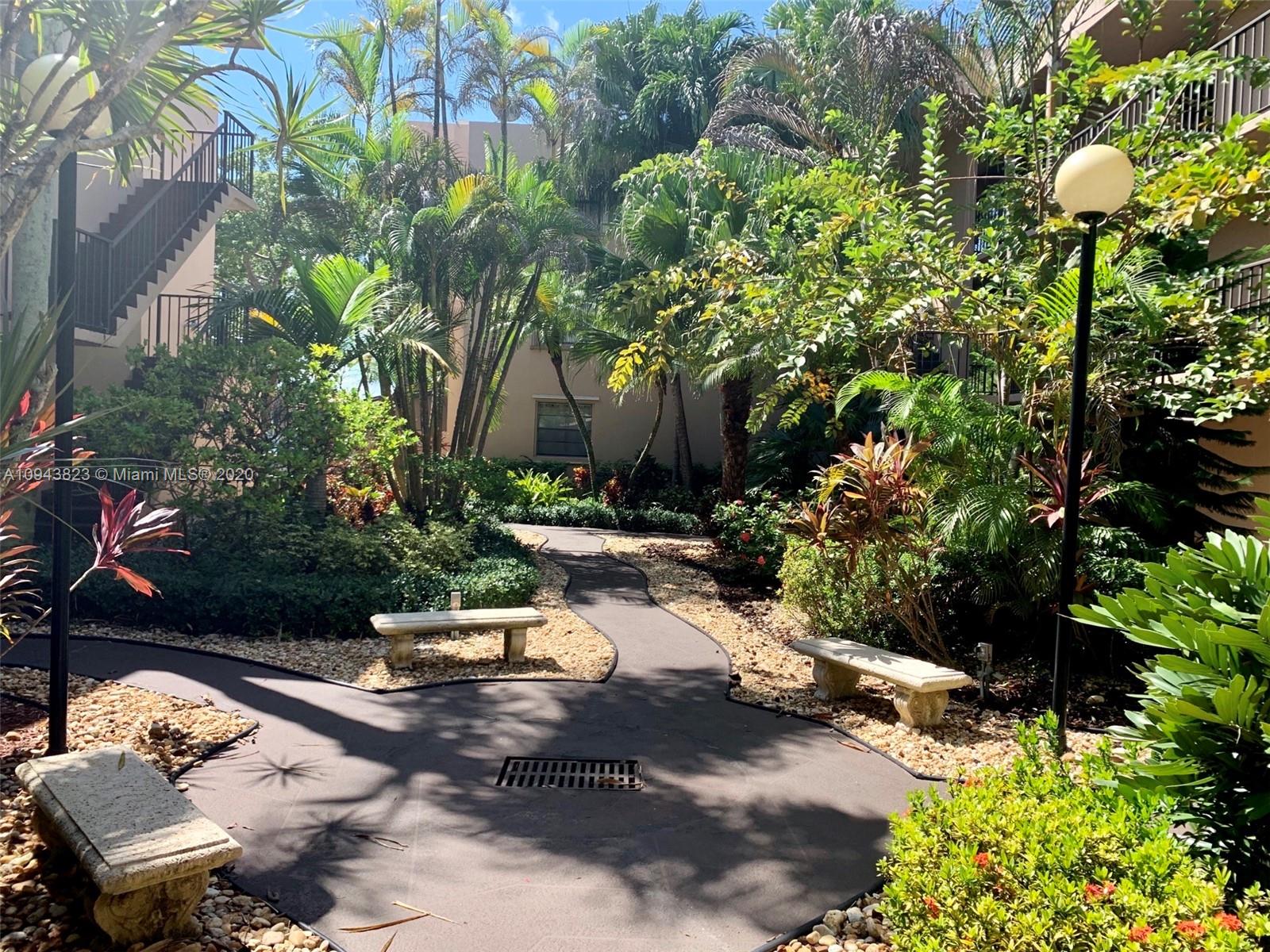 10975 Southwest 107th Street, Unit 117 Miami, FL 33176 - Photo 2 of 13 a backyard of a house with lots of green space