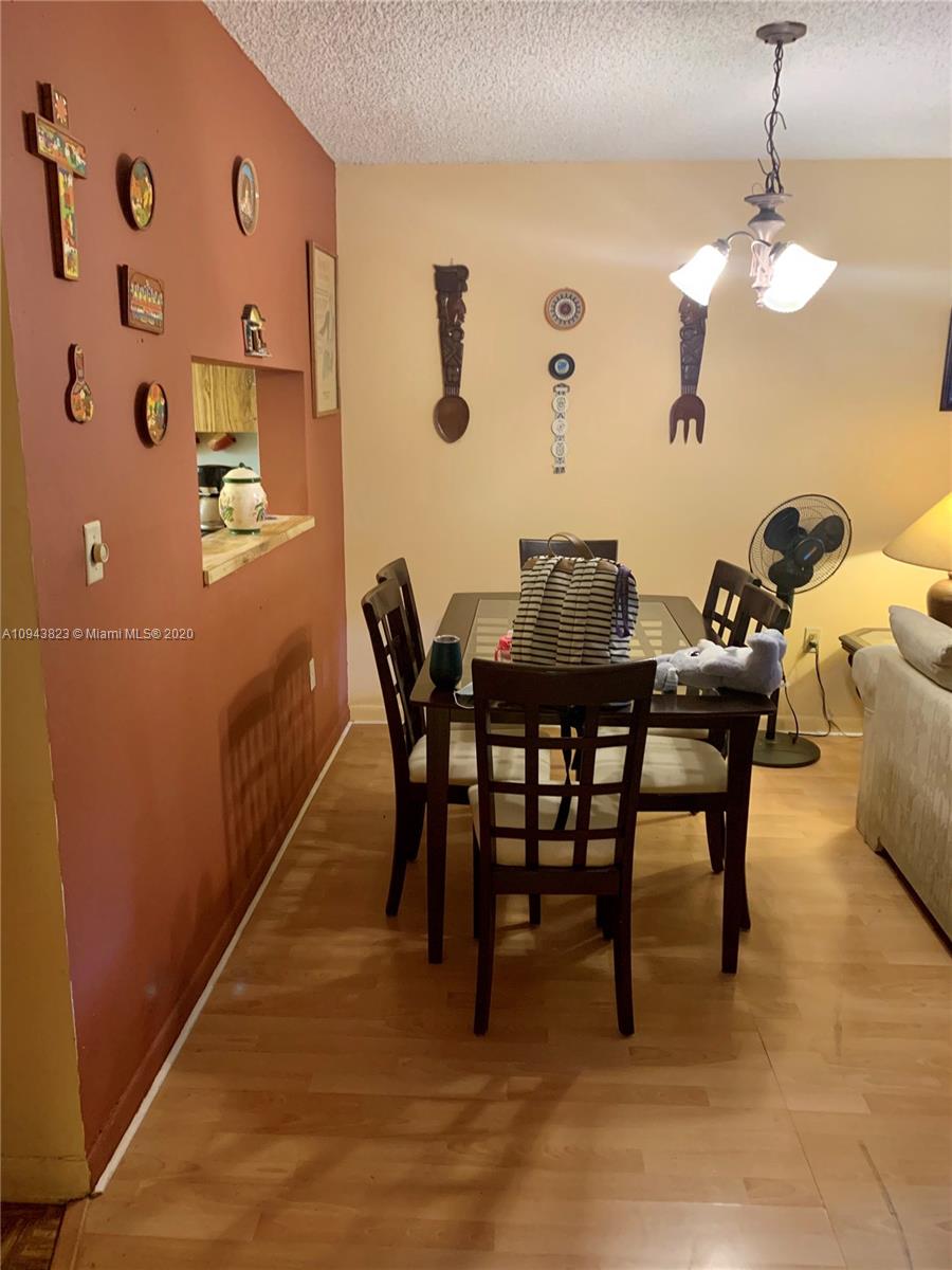 10975 Southwest 107th Street, Unit 117 Miami, FL 33176 - Photo 6 of 13 a view of a dining room with furniture