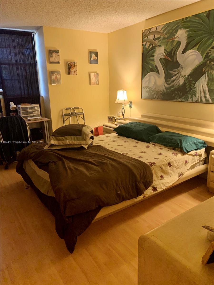 10975 Southwest 107th Street, Unit 117 Miami, FL 33176 - Photo 7 of 13 a bedroom with a bed and dresser