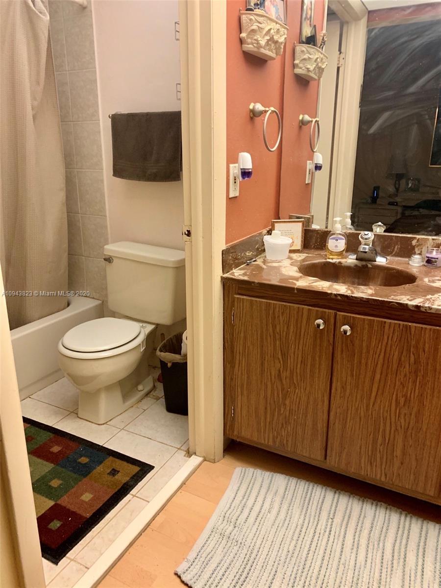 10975 Southwest 107th Street, Unit 117 Miami, FL 33176 - Photo 8 of 13 a bathroom with a sink and a toilet