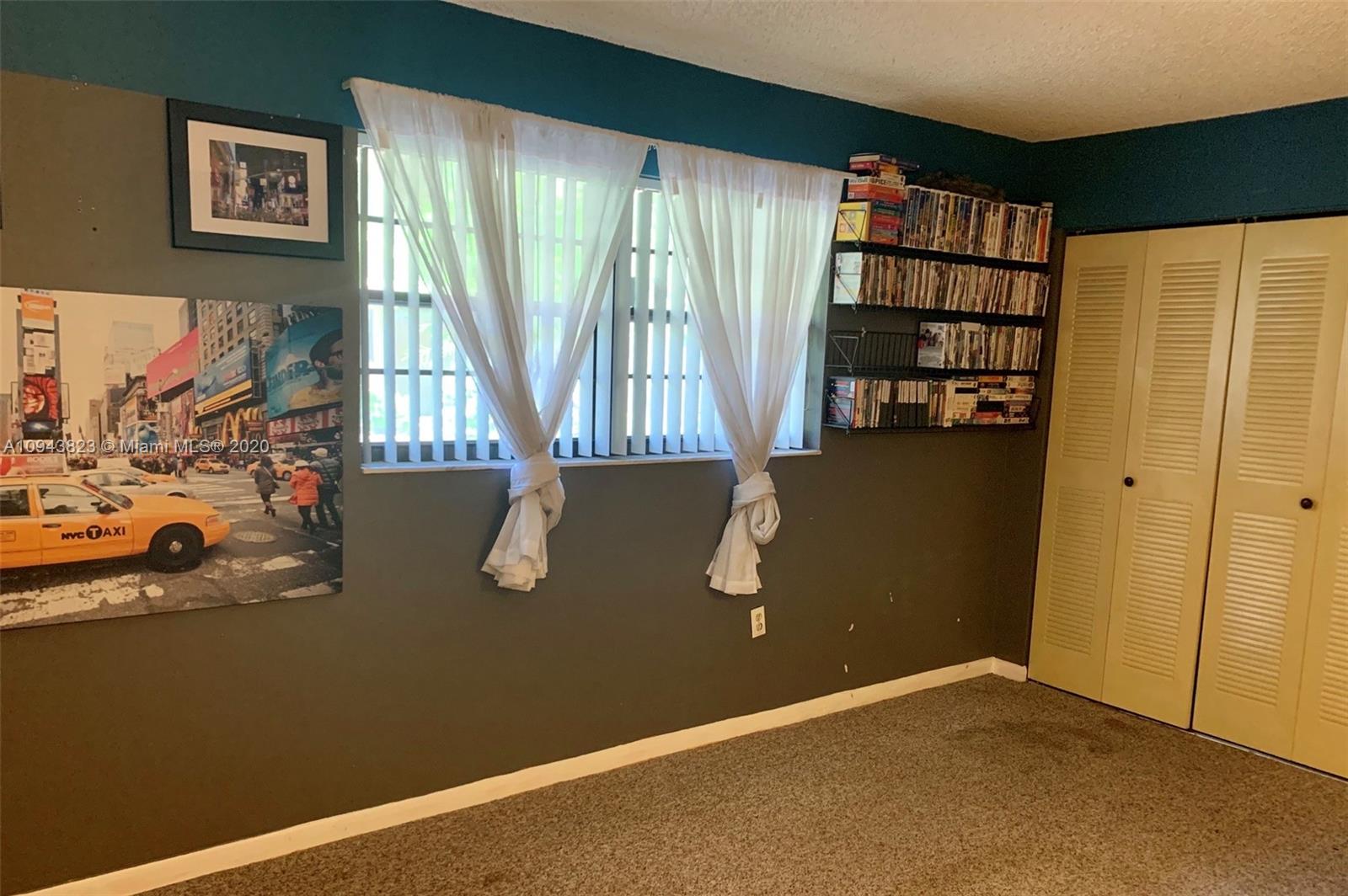 10975 Southwest 107th Street, Unit 117 Miami, FL 33176 - Photo 9 of 13 an empty room with windows