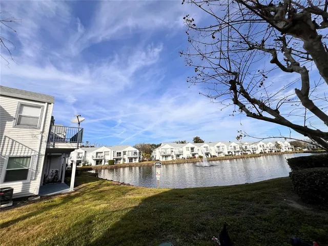 a view of a lake with lawn chairs