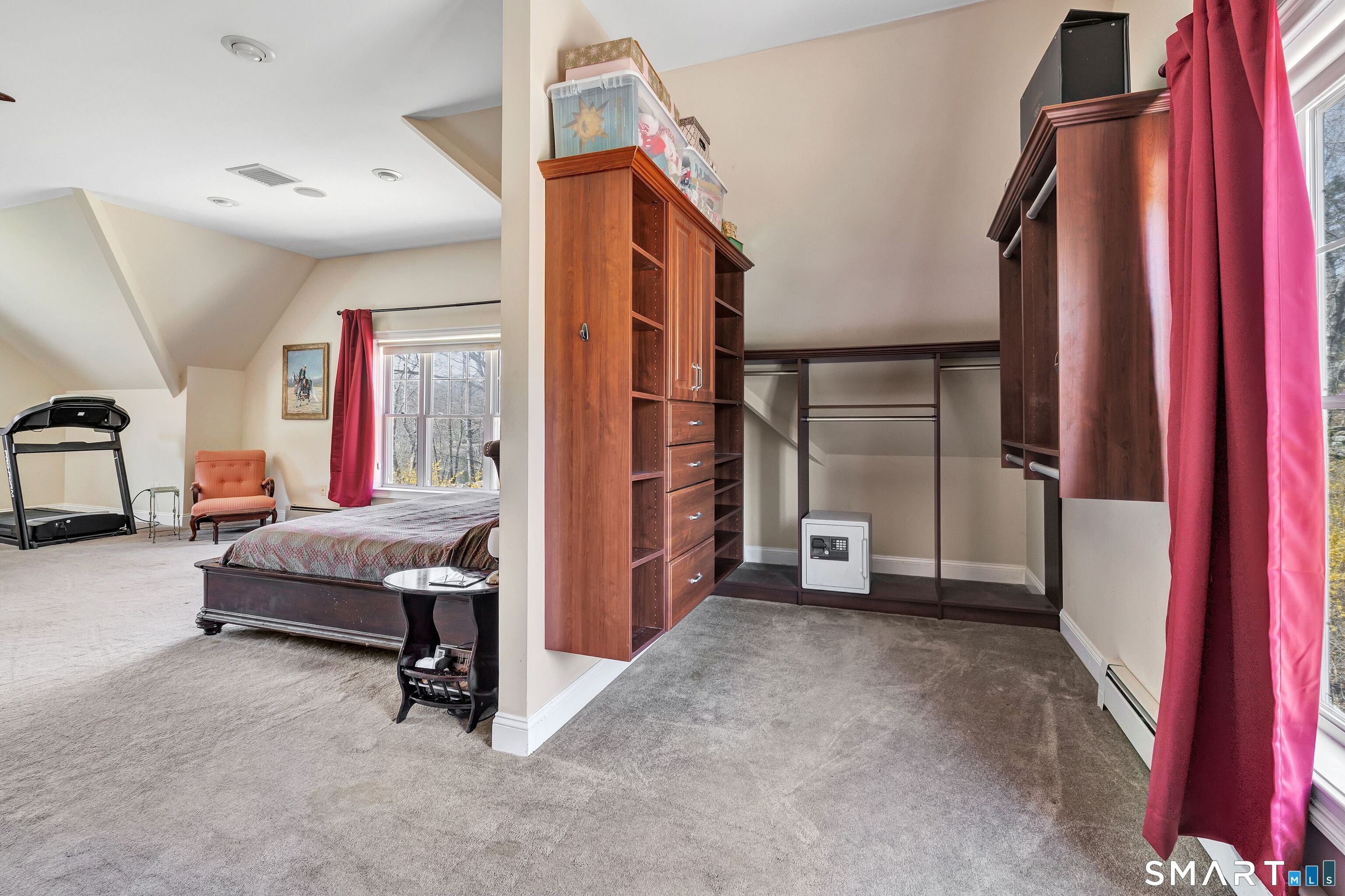 25 Starrs Ridge Road Redding, CT 06896 - Photo 21 of 38 Primary bedroom suite is complemented by this expansive walk-in closet featuring dual-sided wardrobe systems, built-in drawers, shelving, and abundant hanging space.