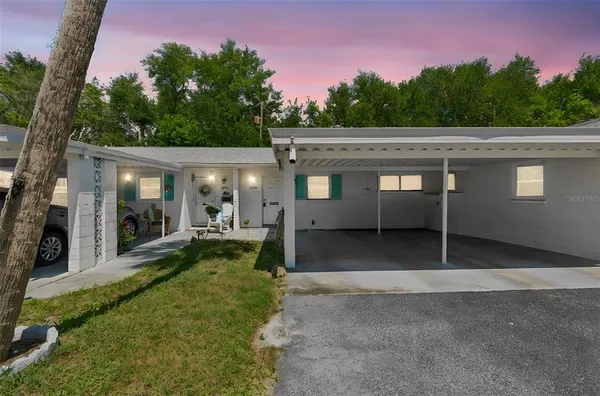 a view of a house with backyard space and garden