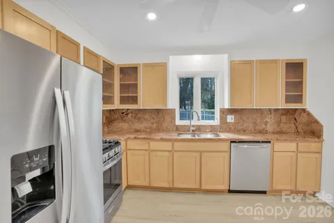 a bathroom with a granite countertop sink a toilet and a shower