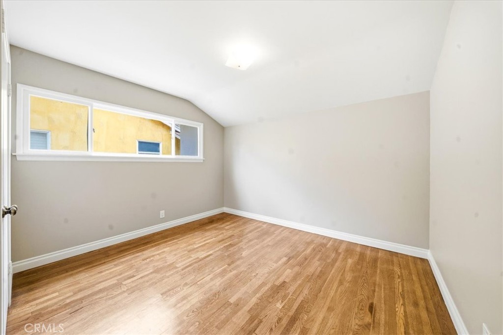 6481 Dos Rios Road Downey, CA 90240 - Photo 24 of 27 a view of an empty room with wooden floor and a window