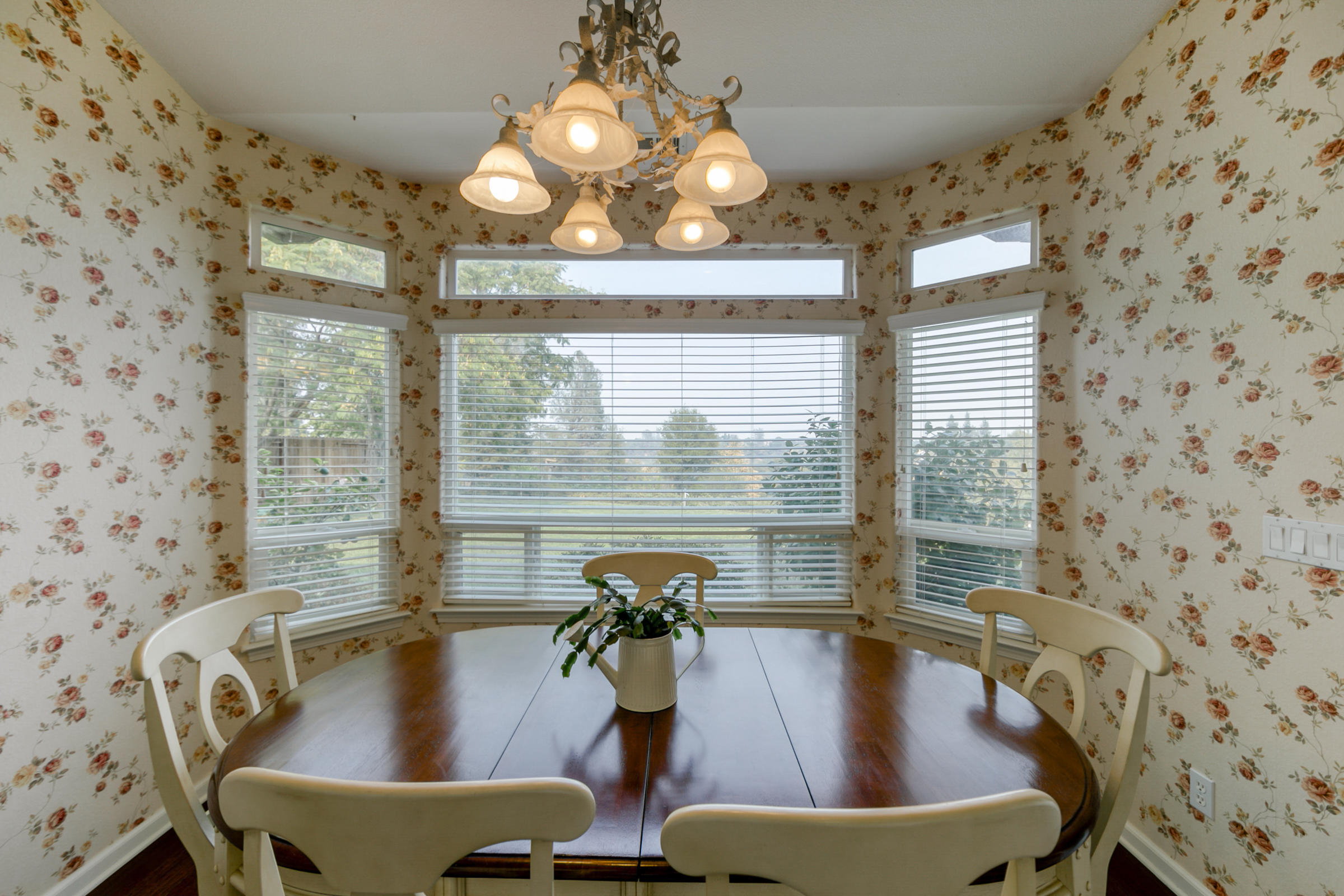 2965 Shadow Brook Lane Redding, CA 96001 - Photo 11 of 38 a view of a dining room with furniture wooden floor and chandelier