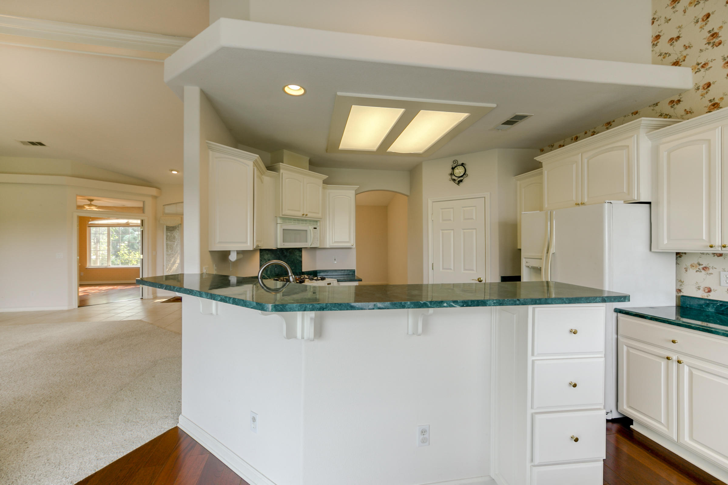 2965 Shadow Brook Lane Redding, CA 96001 - Photo 14 of 38 a kitchen with granite countertop a sink and cabinets