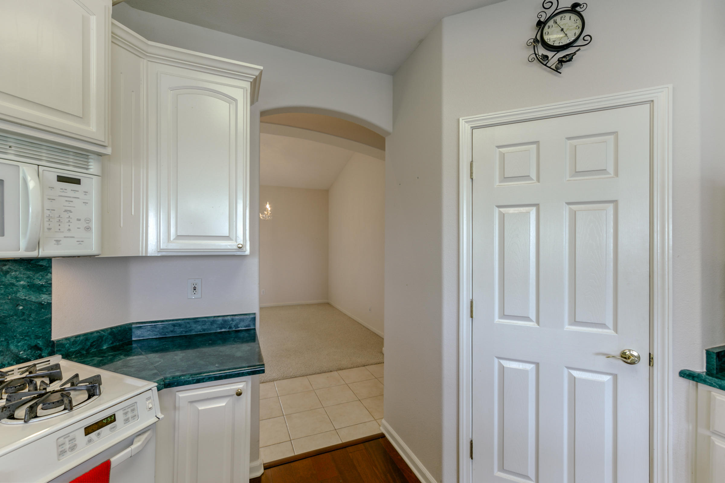 2965 Shadow Brook Lane Redding, CA 96001 - Photo 16 of 38 a kitchen with granite countertop white cabinets and white appliances