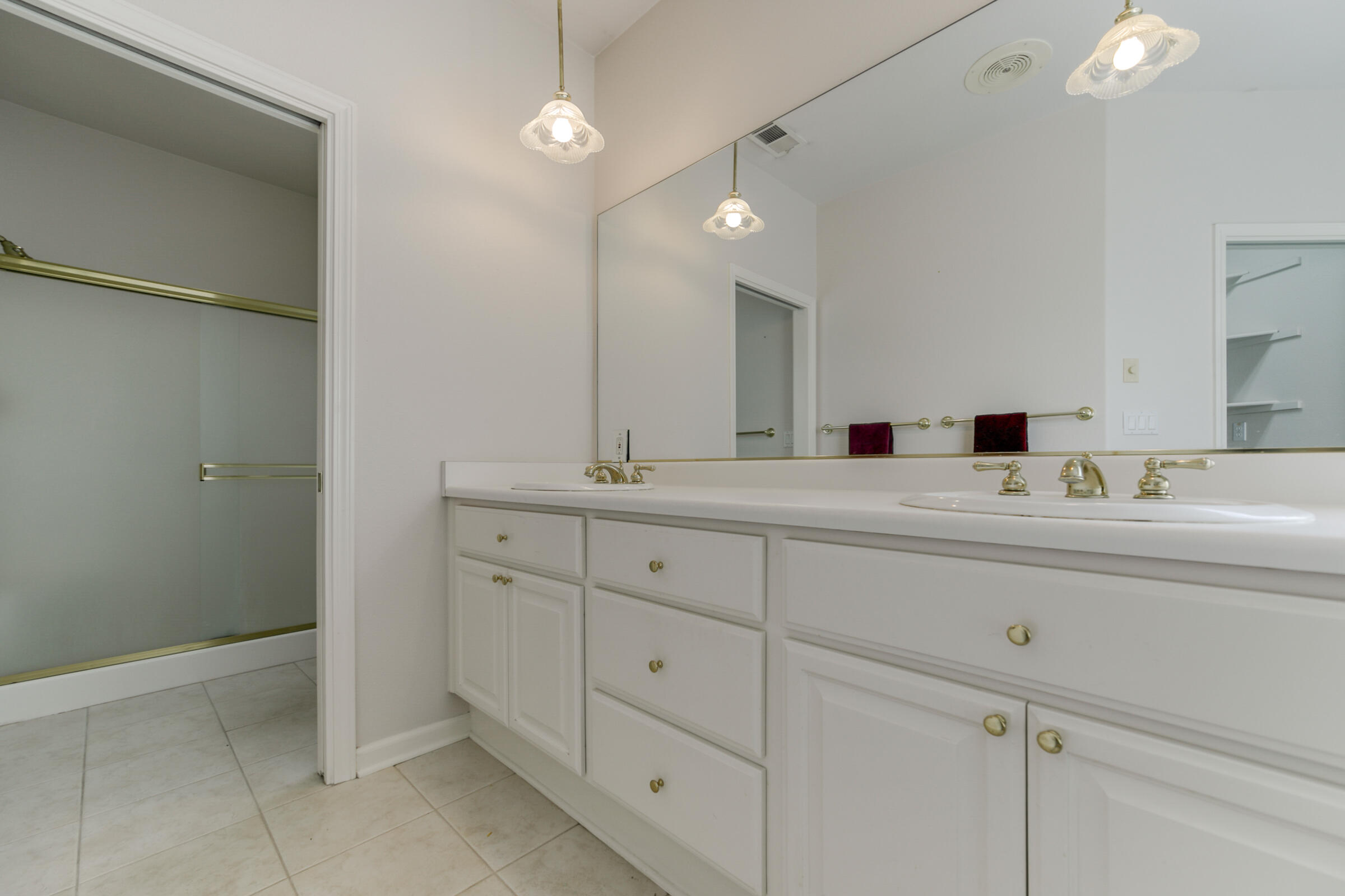 2965 Shadow Brook Lane Redding, CA 96001 - Photo 22 of 38 a bathroom with double sink and a mirror