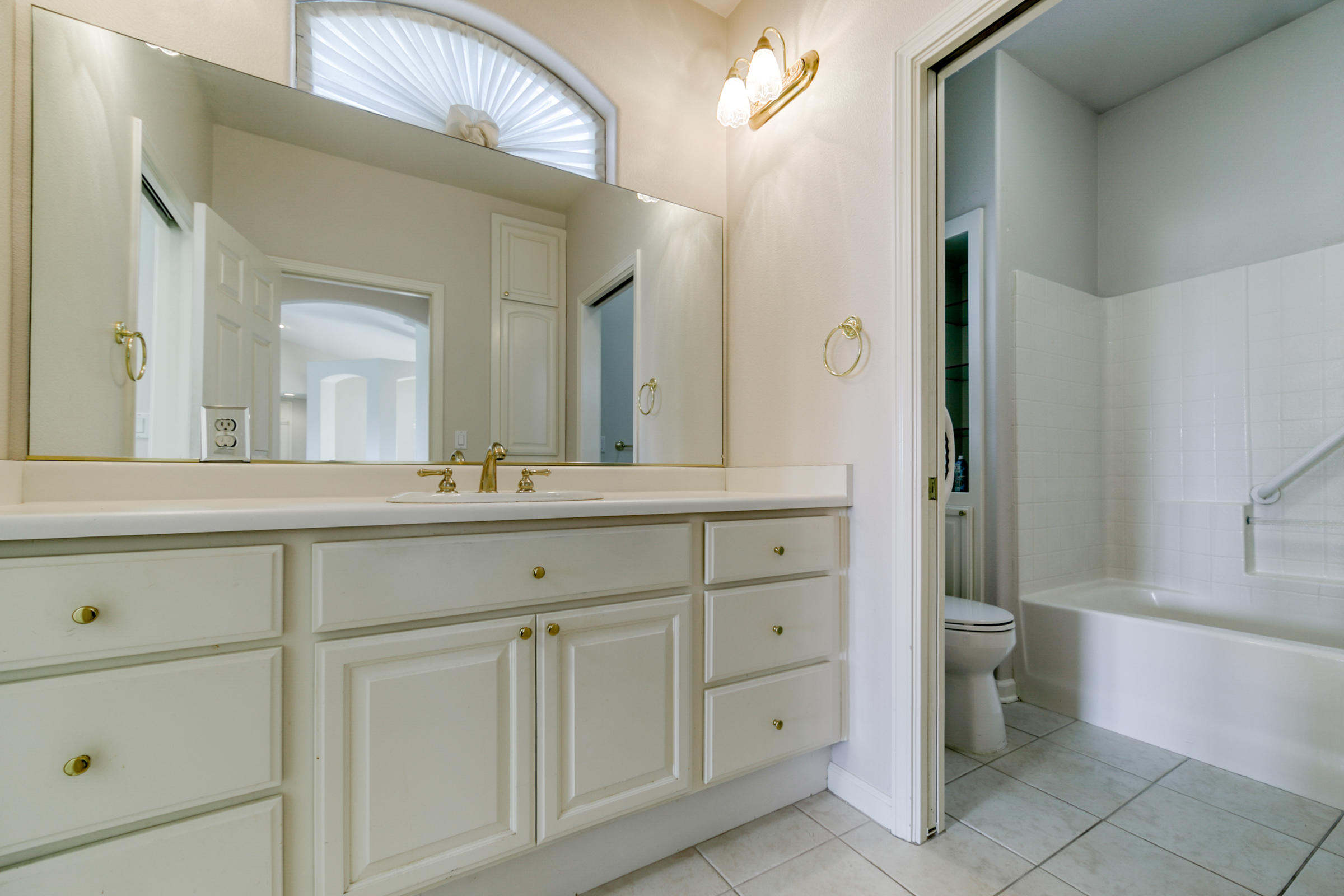 2965 Shadow Brook Lane Redding, CA 96001 - Photo 27 of 38 a bathroom with a double vanity sink and a mirror