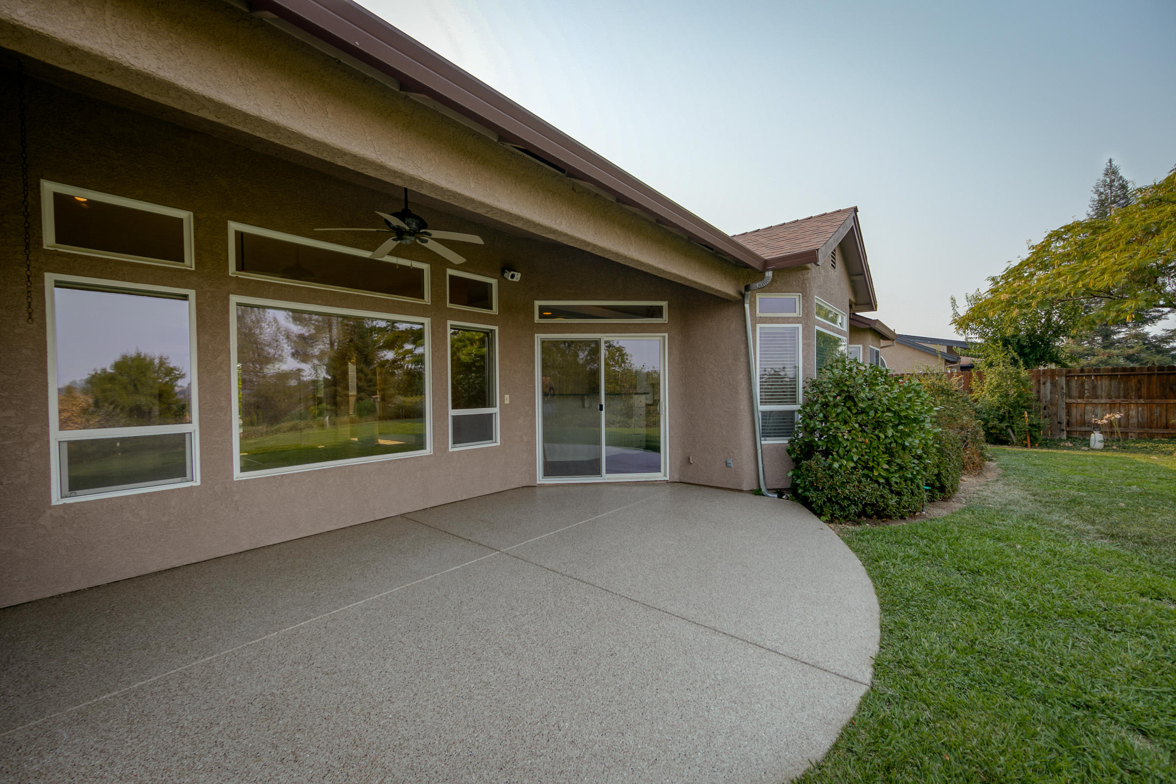 2965 Shadow Brook Lane Redding, CA 96001 - Photo 29 of 38 a view of a house with a large window and a yard