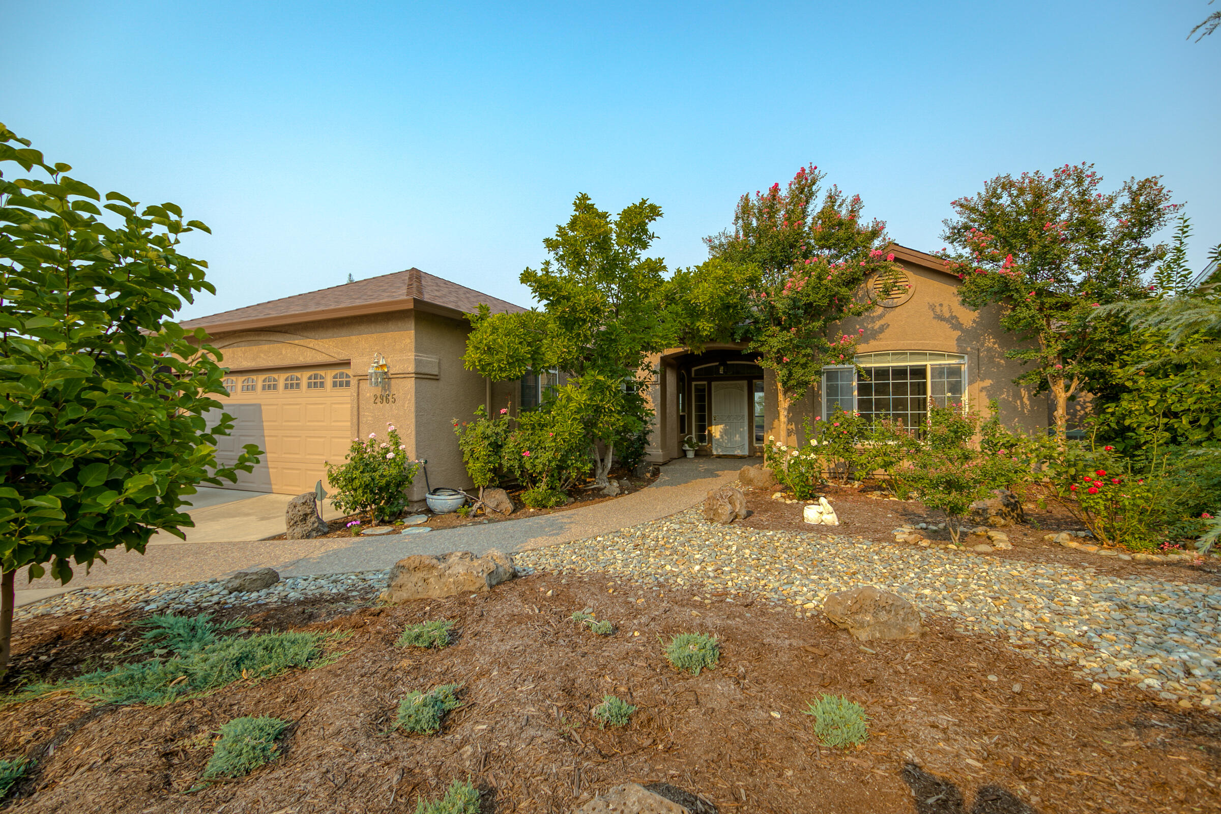 2965 Shadow Brook Lane Redding, CA 96001 - Photo 3 of 38 a front view of a house with a garden