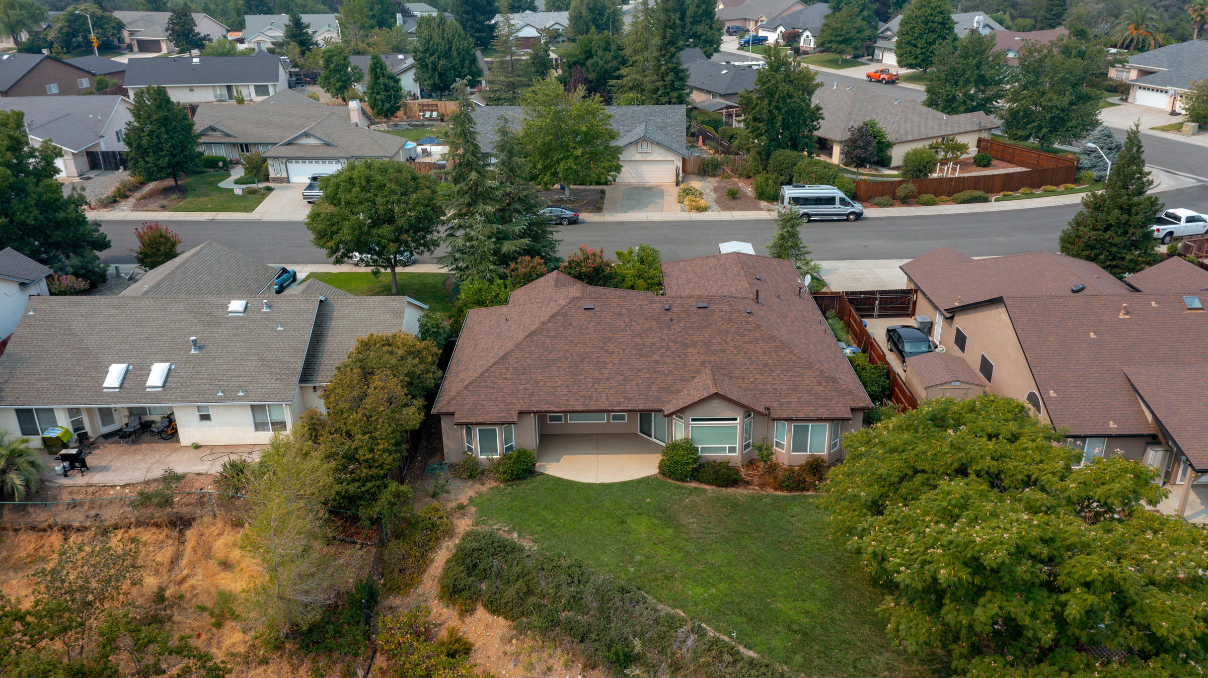 2965 Shadow Brook Lane Redding, CA 96001 - Photo 35 of 38 an aerial view of multiple houses with a yard and street