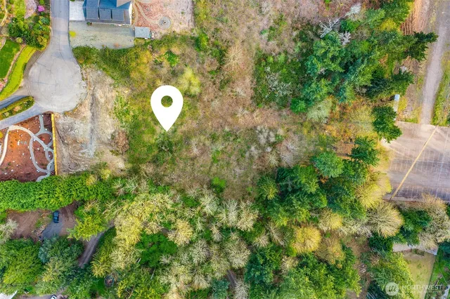 an aerial view of a house with a swimming pool and garden