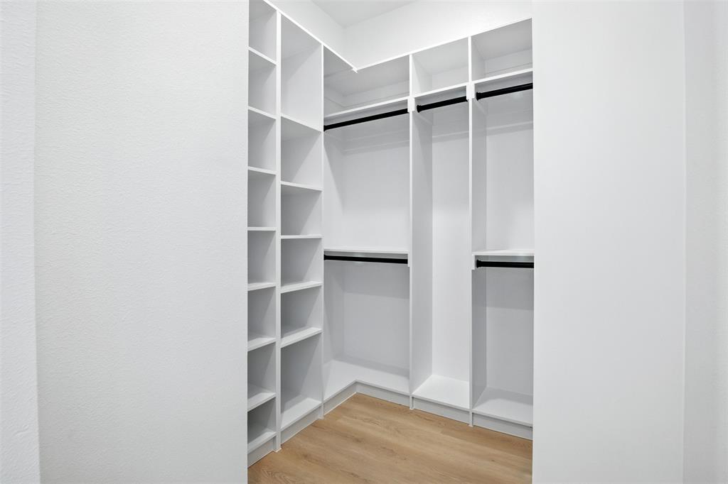 4611 Fairmount Street, Unit 102 Dallas, TX 75219 - Photo 24 of 34 a view of an empty walk in closet with empty racks