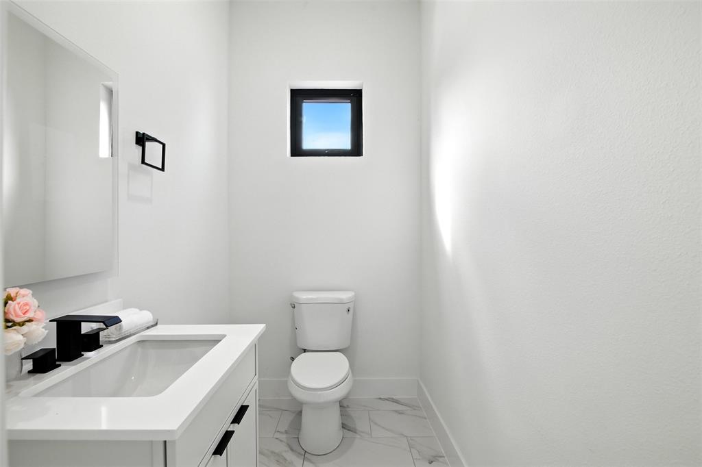 4611 Fairmount Street, Unit 102 Dallas, TX 75219 - Photo 27 of 34 a white toilet sitting next to a white sink
