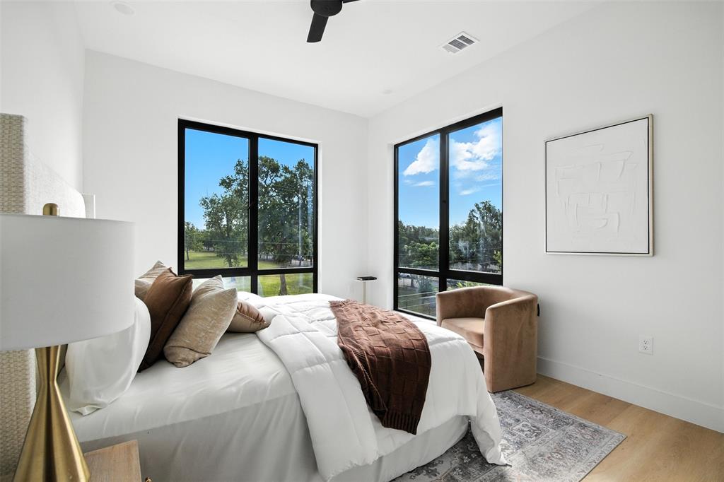 4611 Fairmount Street, Unit 102 Dallas, TX 75219 - Photo 7 of 34 a bedroom with furniture and a window