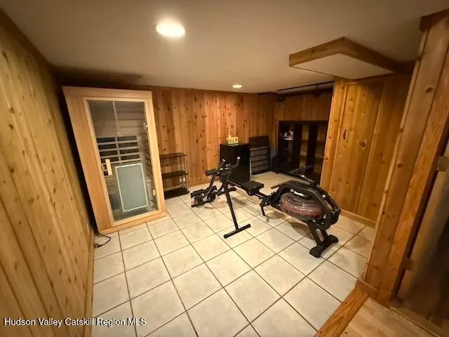 a room with gym equipment and a mirror
