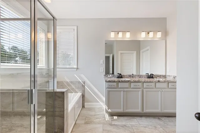 a large bathroom with a double vanity sink and mirror