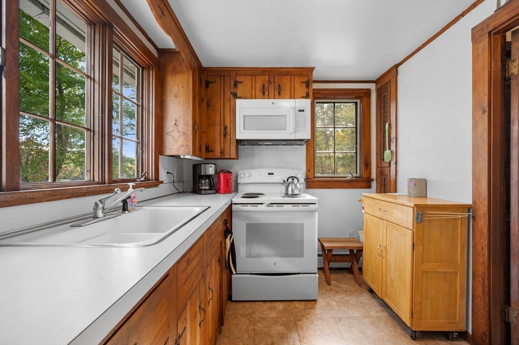 95 Crockett Road Upton, MA 01757 - Photo 11 of 26 a kitchen with a sink stove top oven and refrigerator