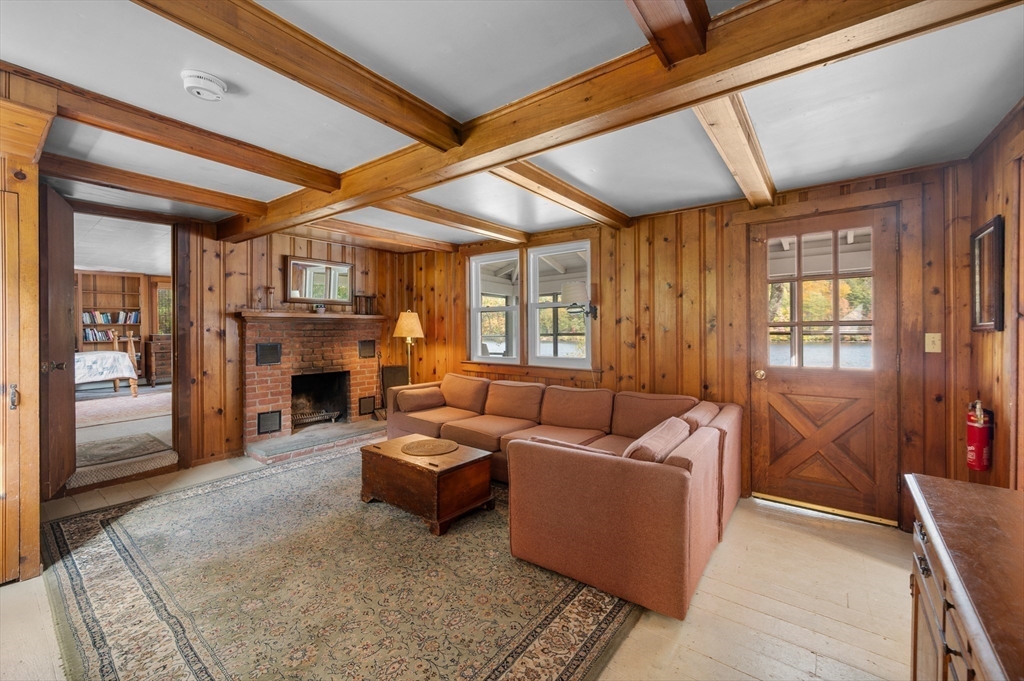 95 Crockett Road Upton, MA 01757 - Photo 16 of 26 a living room with furniture a fireplace and a window