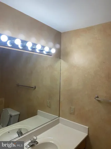 a bathroom with a shower a toilet and a sink