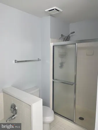 a bathroom with a shower and toilet