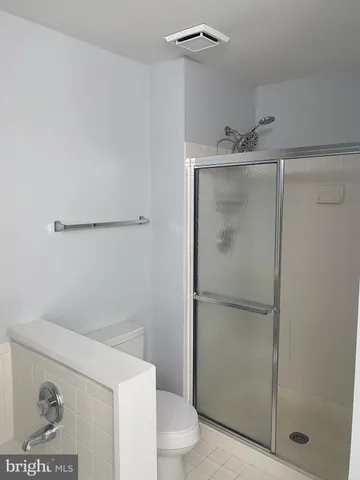 a bathroom with a shower and toilet