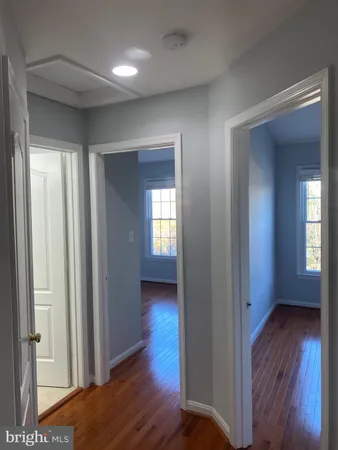 a view of hallway with wooden floor