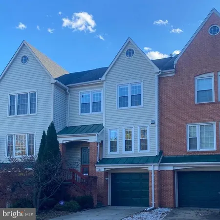 a front view of a house with plants