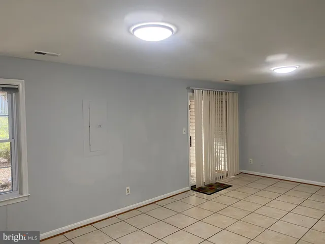 a bathroom with a granite countertop toilet and a shower
