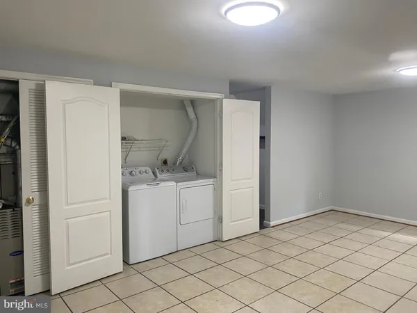 a white toilet sitting next to a shower