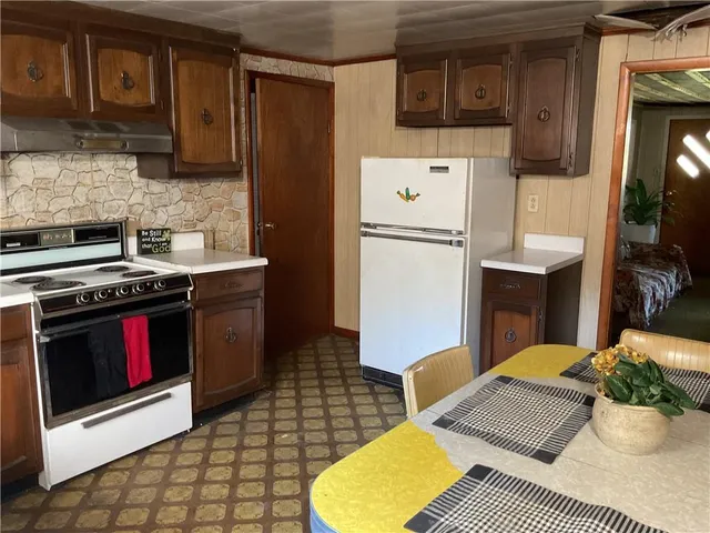 a kitchen with a sink appliances and cabinets