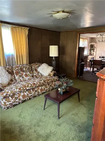 a bedroom with a bed mirror and window
