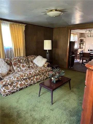 a bedroom with a bed mirror and window