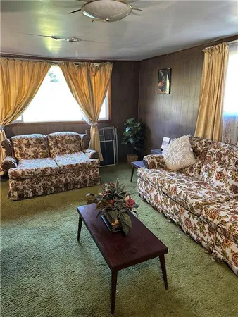 a bedroom with a bed chair and window