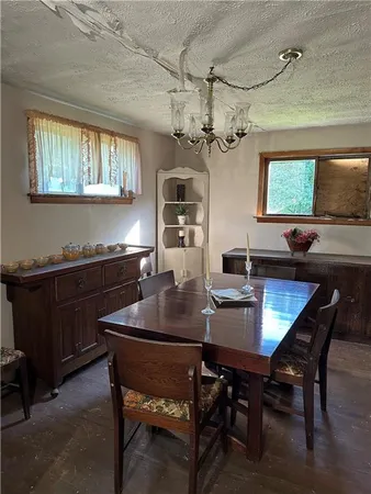 a dining room with a wooden table and chairs
