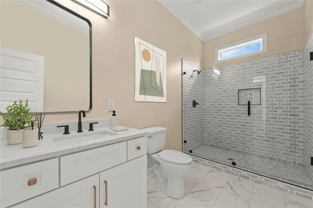 5011 Colton Run Atlanta, GA 30349 - Photo 12 of 12 a bathroom with a toilet sink shower and mirror