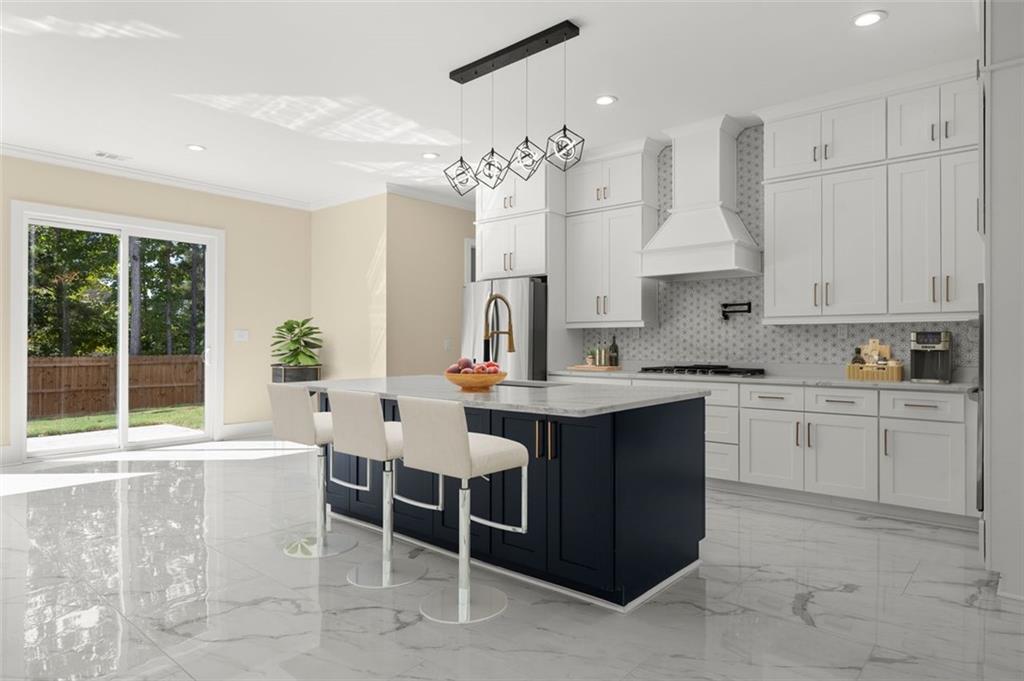 5011 Colton Run Atlanta, GA 30349 - Photo 5 of 12 a kitchen with granite countertop a sink and white cabinets