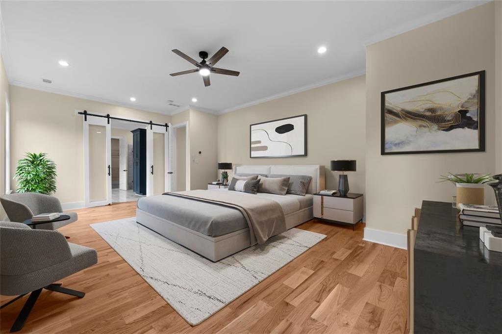 5011 Colton Run Atlanta, GA 30349 - Photo 7 of 12 a spacious bedroom with a bed a couch and potted plant on the dresser
