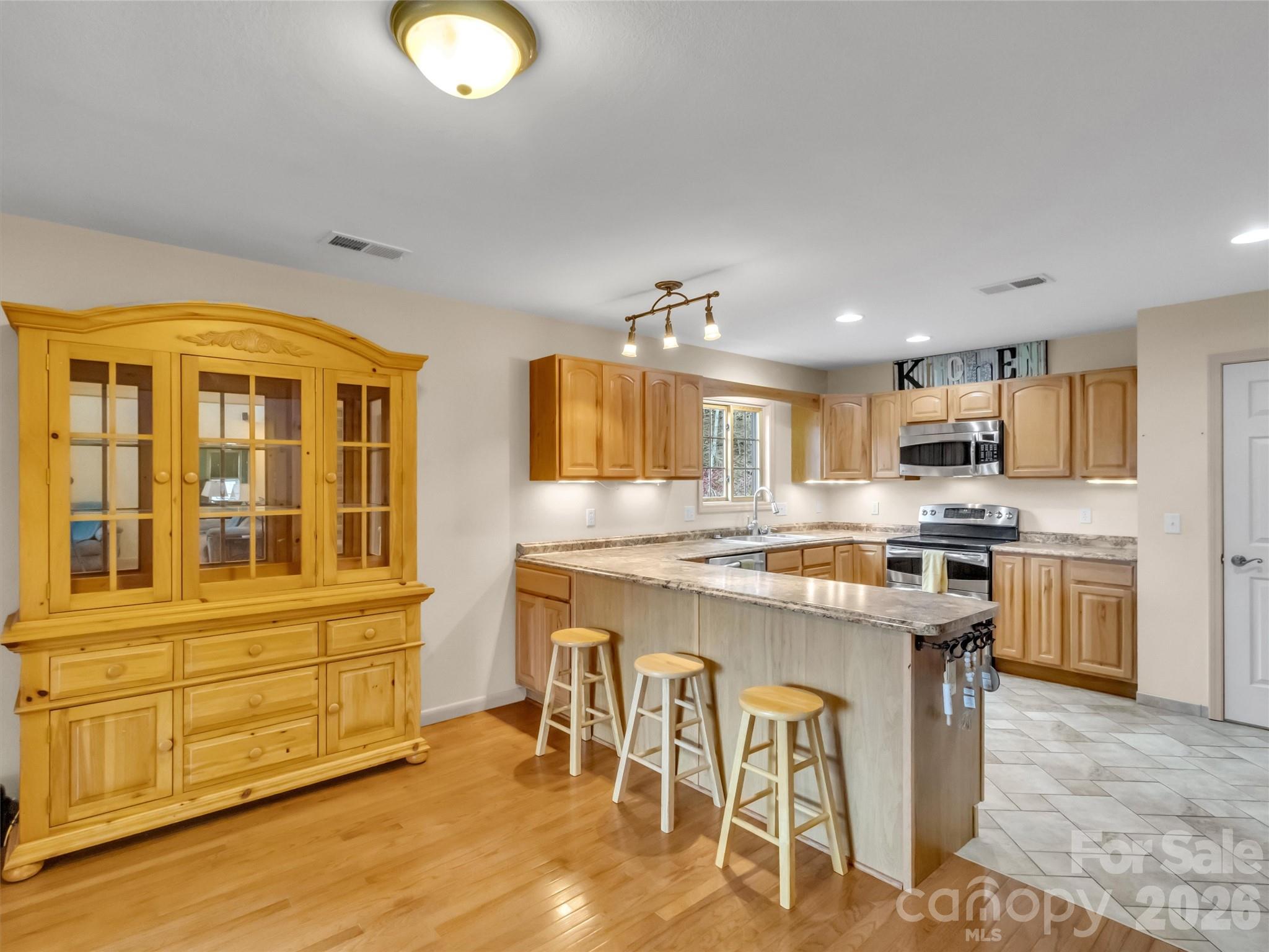 115 Fugitive Run Sylva, NC 28779 - Photo 11 of 47 a kitchen with cabinets and wooden floor