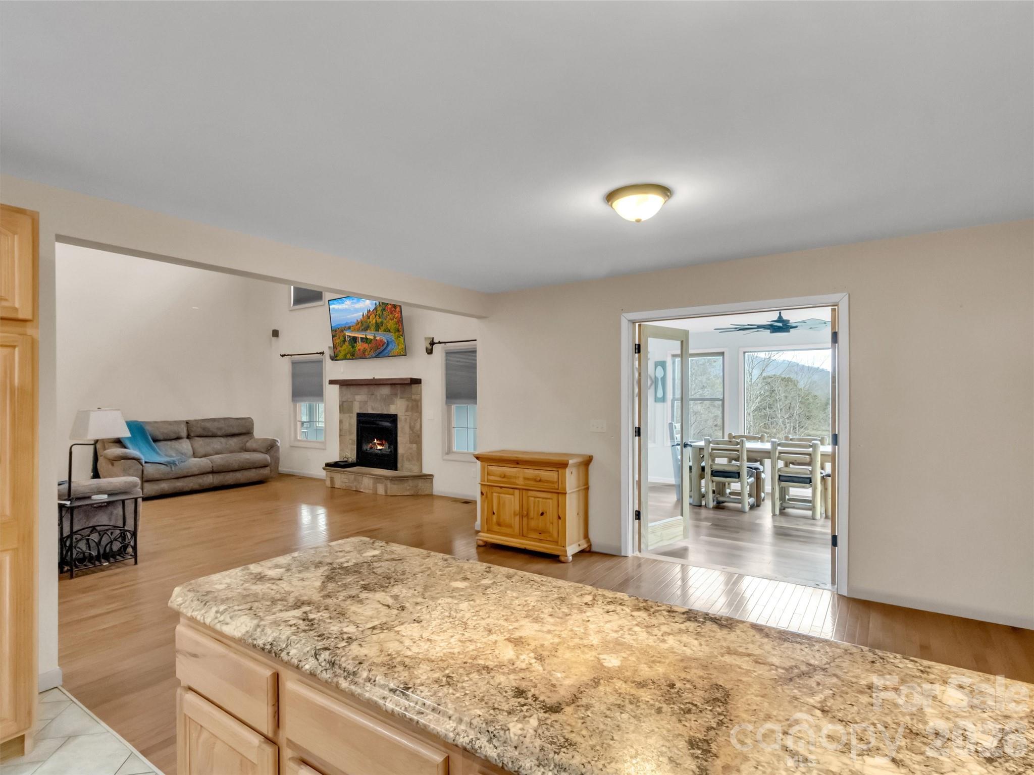 115 Fugitive Run Sylva, NC 28779 - Photo 13 of 47 a living room with furniture and a fireplace with wooden floor